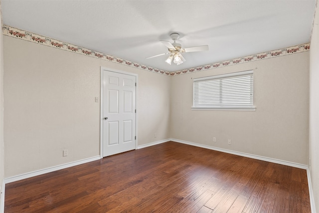 unfurnished room featuring dark wood-type flooring and ceiling fan