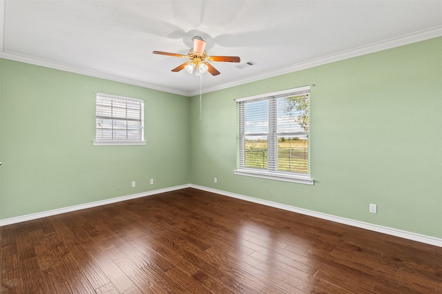 empty room featuring a wealth of natural light, ceiling fan, ornamental molding, and hardwood / wood-style flooring