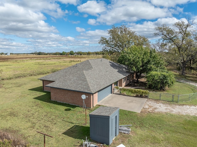 birds eye view of property with a rural view