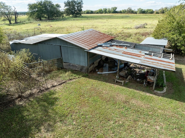 exterior space featuring a rural view and a lawn