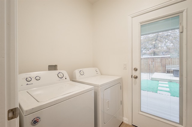 laundry area with separate washer and dryer and a healthy amount of sunlight