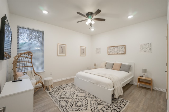 bedroom with ceiling fan and light hardwood / wood-style flooring