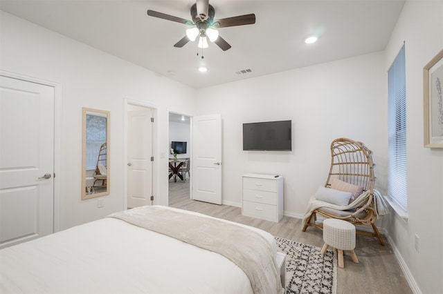 bedroom featuring light wood-type flooring and ceiling fan