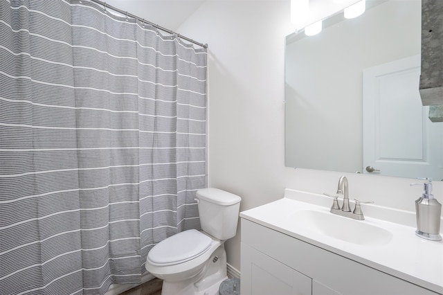 bathroom featuring toilet, a shower with curtain, and vanity