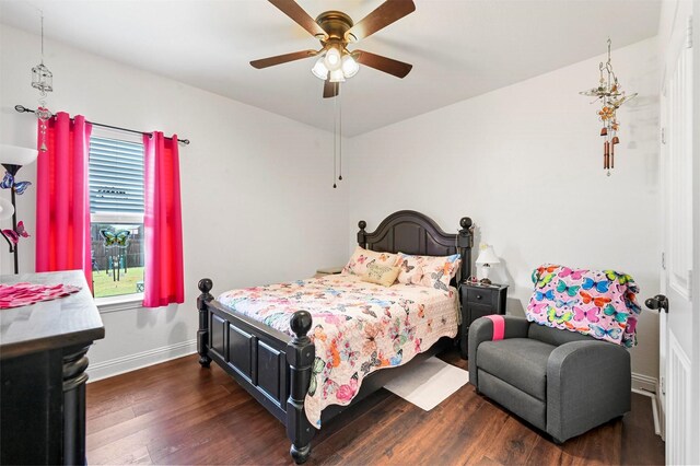 bedroom with dark wood-type flooring, vaulted ceiling, and multiple windows