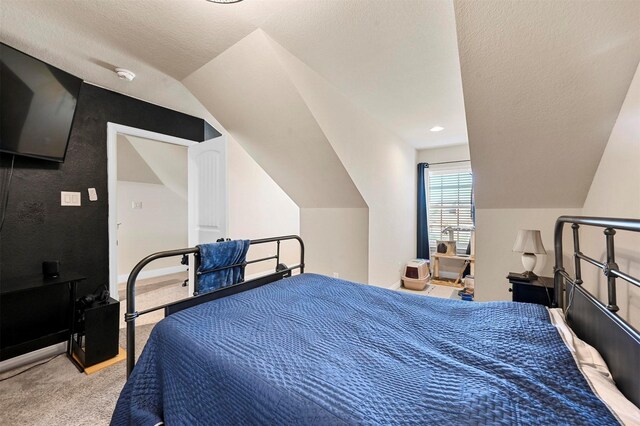 bedroom featuring lofted ceiling and light carpet