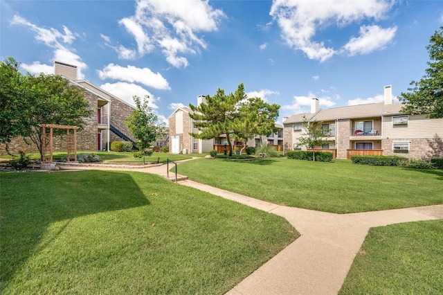 view of property's community featuring a yard