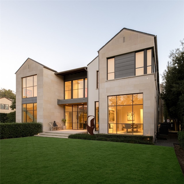 rear view of house featuring a lawn and a patio area