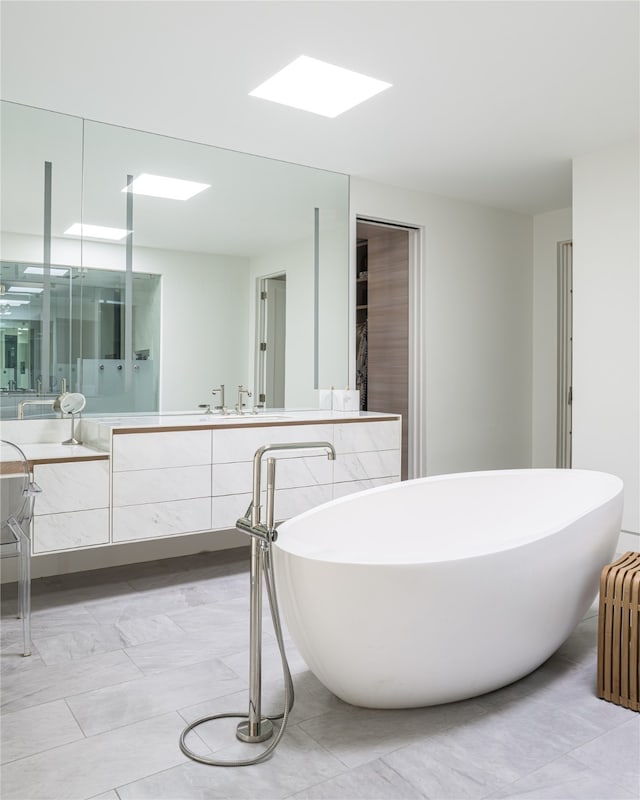 bathroom featuring radiator, vanity, and a tub