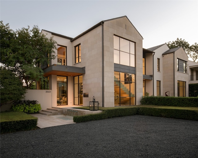 back of house featuring a balcony