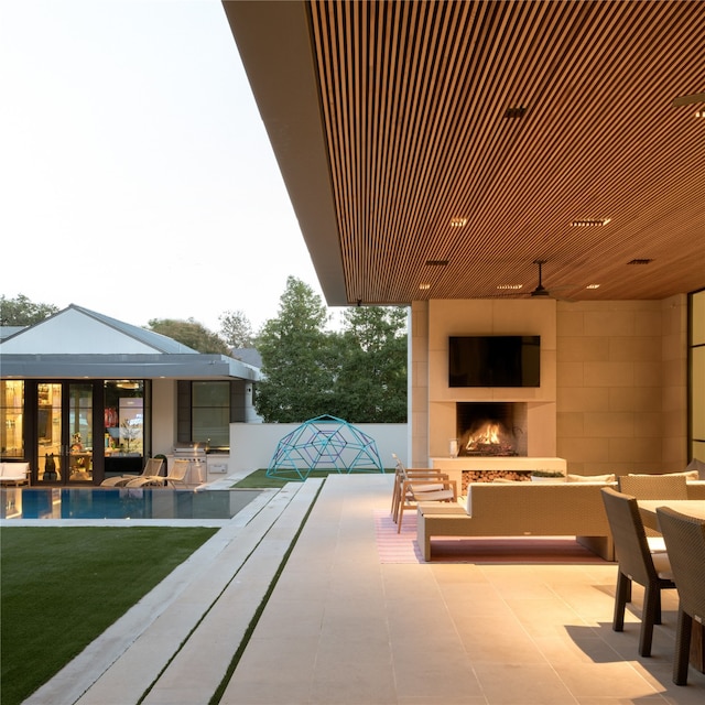 view of patio with an outdoor fireplace