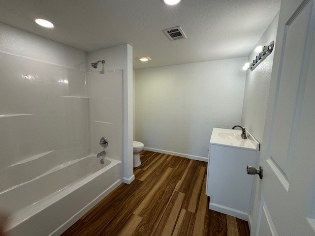 full bathroom featuring wood-type flooring, vanity, toilet, and bathing tub / shower combination