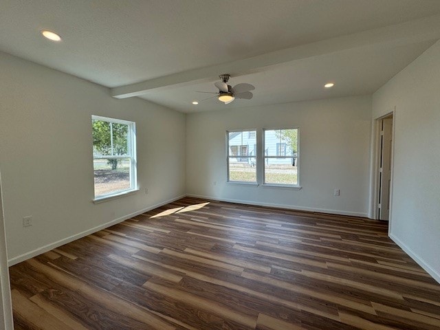 spare room with dark wood-type flooring, beamed ceiling, and ceiling fan