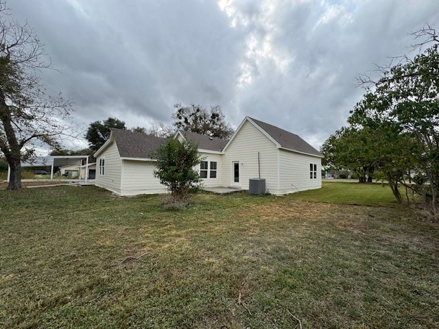 view of side of home with a yard