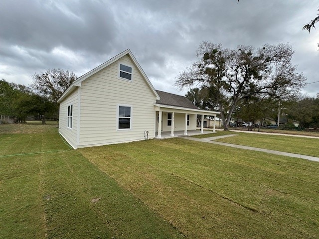 rear view of property featuring a yard