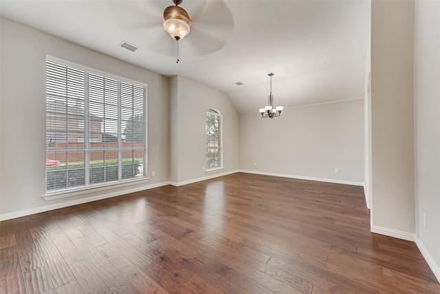 unfurnished room featuring ceiling fan with notable chandelier, dark hardwood / wood-style flooring, and vaulted ceiling