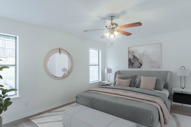 bedroom with light hardwood / wood-style flooring and ceiling fan