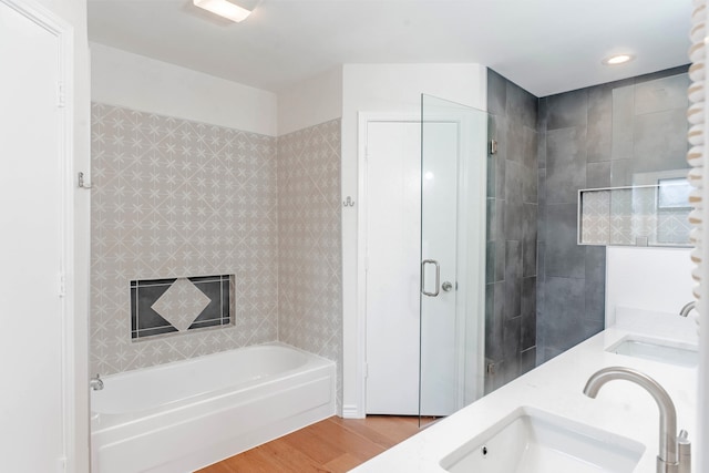 bathroom featuring vanity, hardwood / wood-style floors, and independent shower and bath