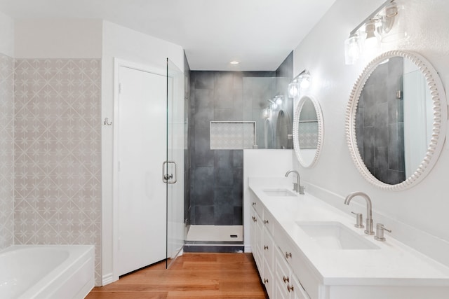 bathroom with vanity, separate shower and tub, and hardwood / wood-style floors