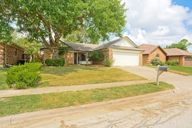 ranch-style home featuring a garage and a front yard