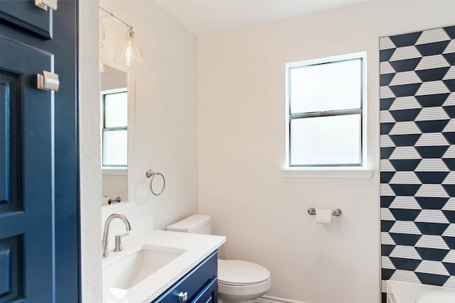 bathroom with vanity, a shower with shower curtain, and toilet