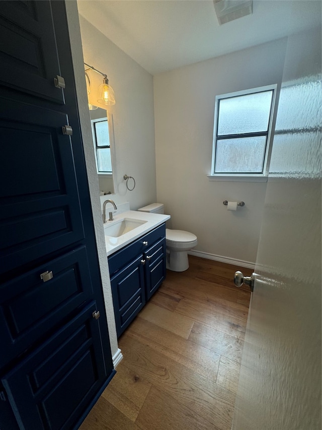 bathroom featuring vanity, hardwood / wood-style floors, and toilet