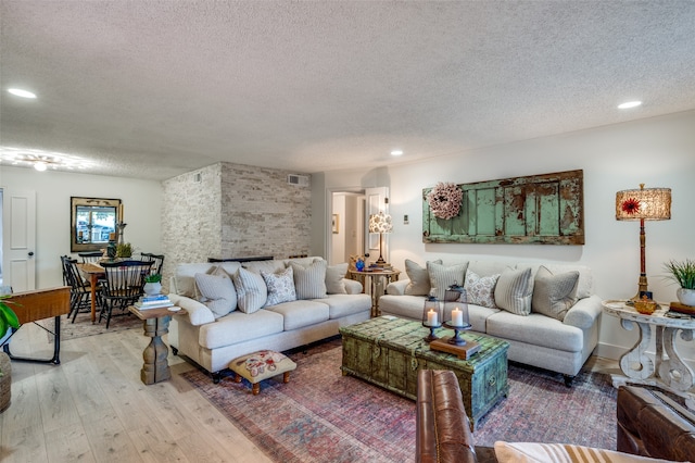 living room with hardwood / wood-style floors and a textured ceiling