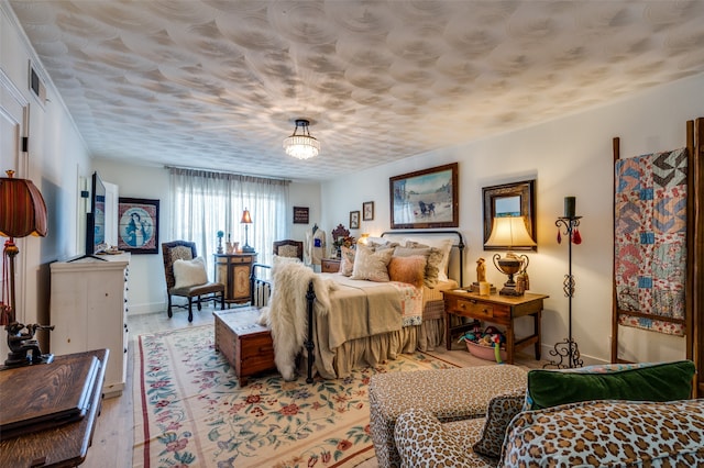 bedroom with light hardwood / wood-style flooring