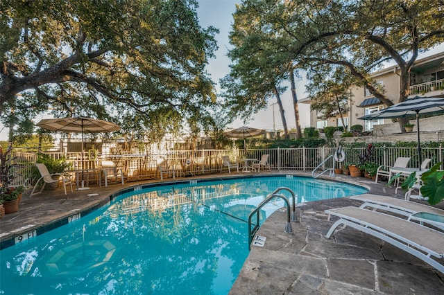 view of swimming pool with a patio area