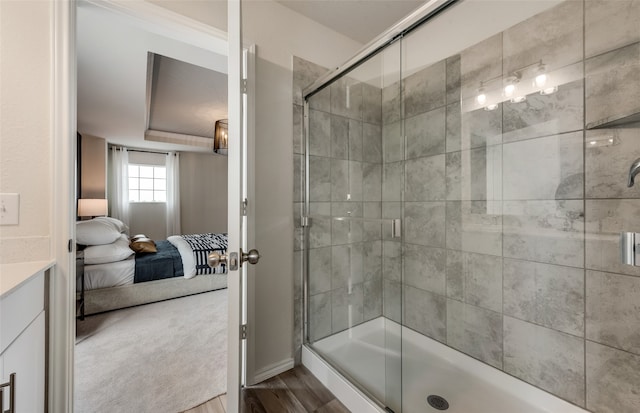 bathroom featuring hardwood / wood-style flooring and walk in shower