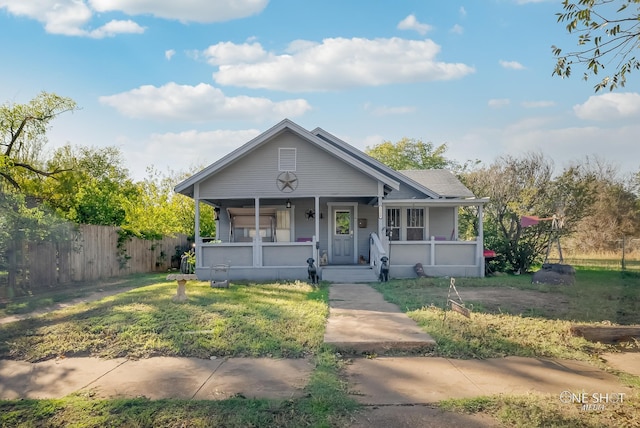 bungalow-style home with a porch and a front lawn