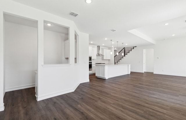 unfurnished living room featuring dark hardwood / wood-style floors and sink