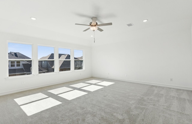 carpeted empty room featuring ceiling fan