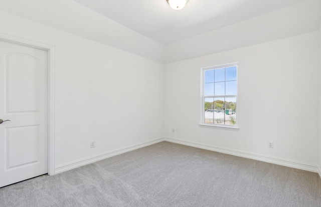 spare room featuring light carpet