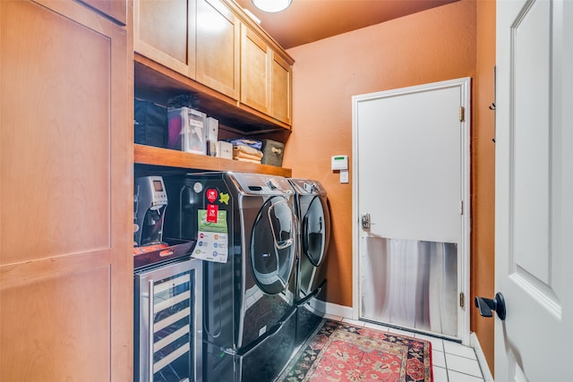 laundry area featuring washing machine and clothes dryer, cabinets, light tile patterned floors, and wine cooler