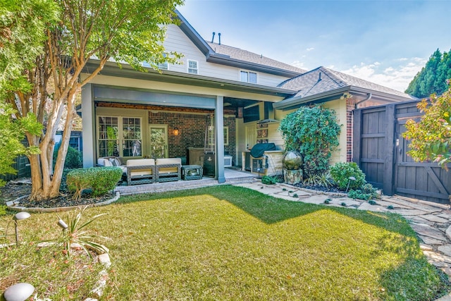 7009 Sharps Dr, Plano, TX 75025 - back of house with an outdoor hangout area, a lawn, a gate, and brick siding