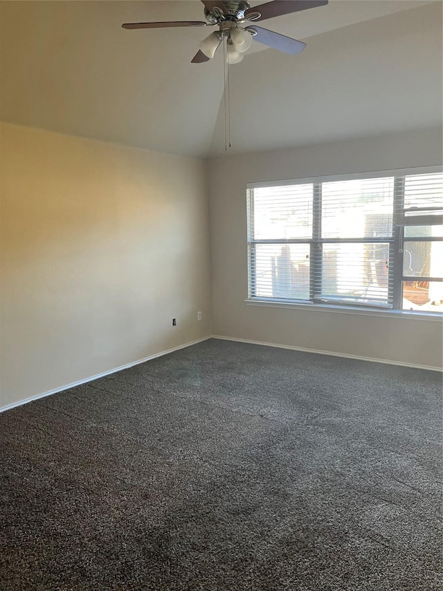 spare room with ceiling fan, carpet, and vaulted ceiling