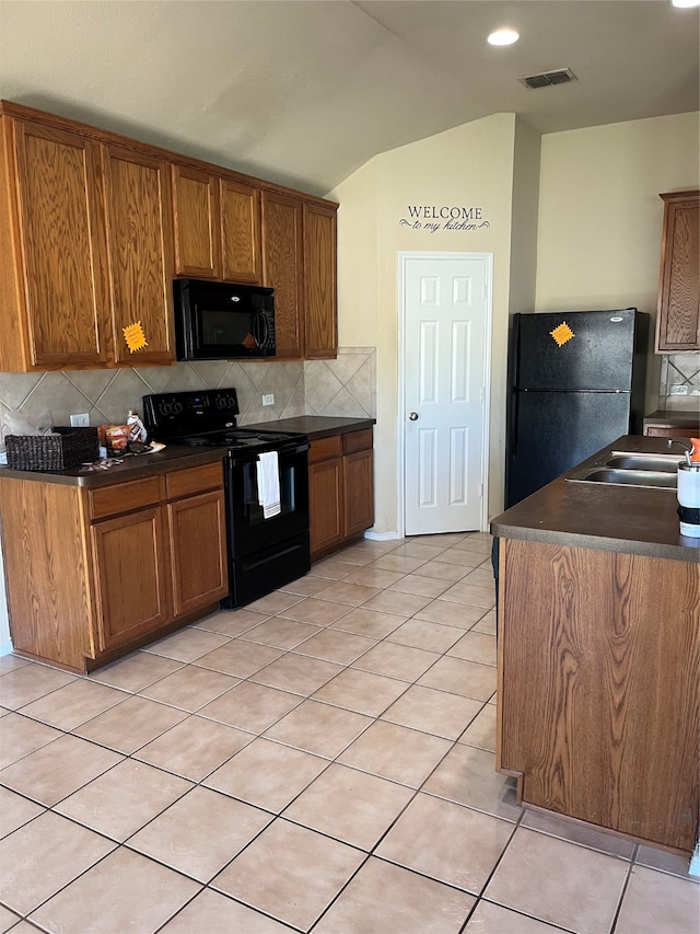 kitchen featuring black appliances, sink, tasteful backsplash, and light tile patterned floors