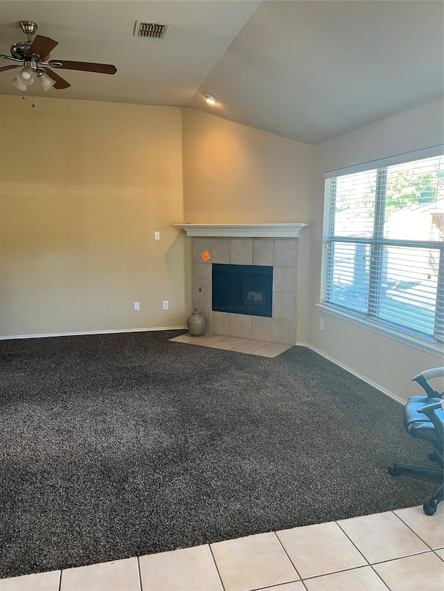 unfurnished living room featuring a fireplace, light colored carpet, vaulted ceiling, and ceiling fan