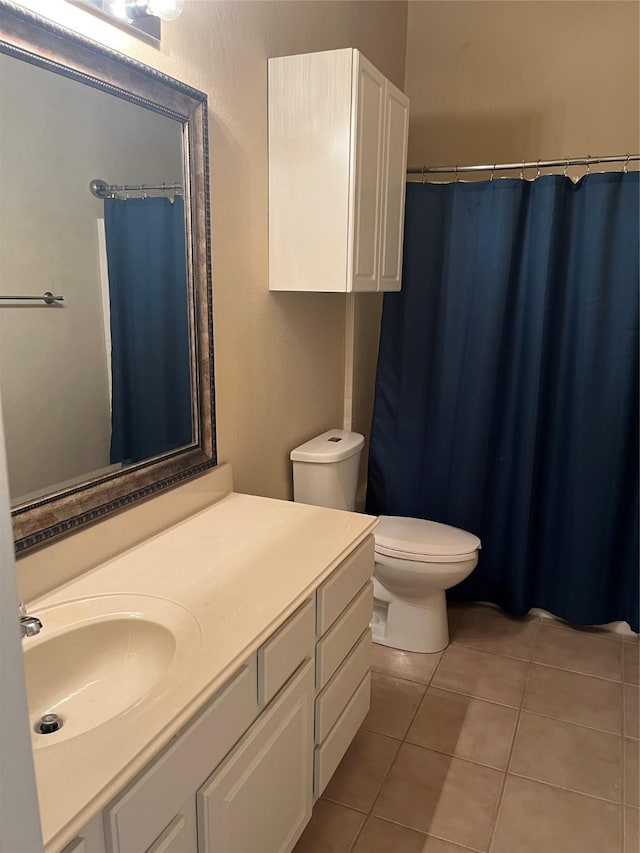 bathroom with vanity, toilet, and tile patterned flooring