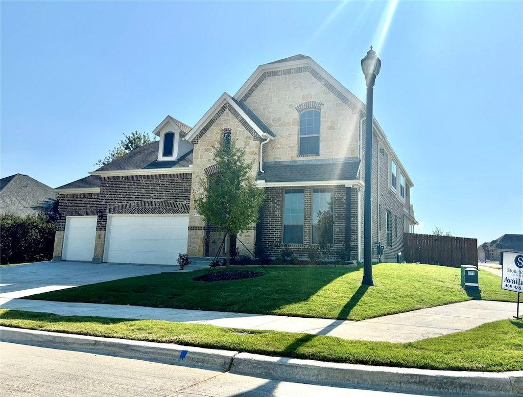 front facade featuring a garage and a front yard