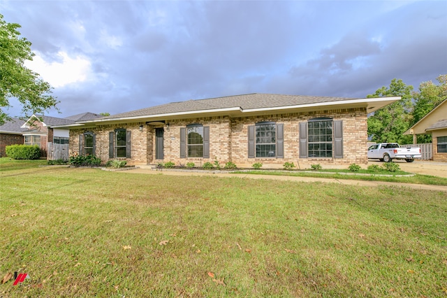 ranch-style home with a front lawn