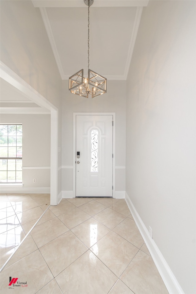 entrance foyer with high vaulted ceiling, a chandelier, light tile patterned floors, and ornamental molding