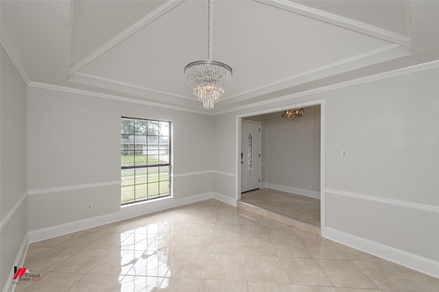 unfurnished room with a tray ceiling, ornamental molding, light tile patterned floors, and a notable chandelier