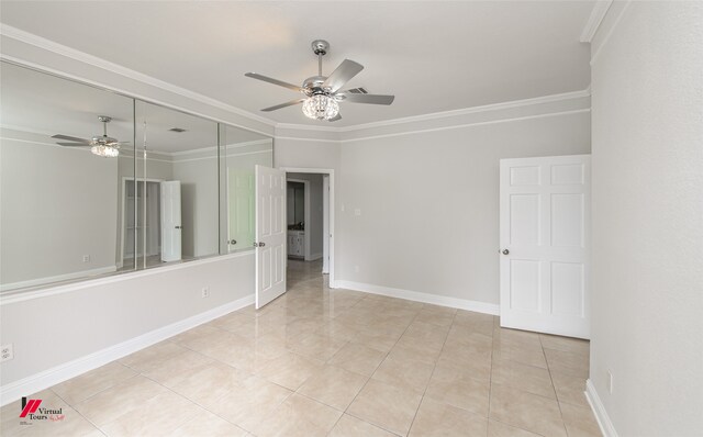 tiled empty room featuring ceiling fan and ornamental molding