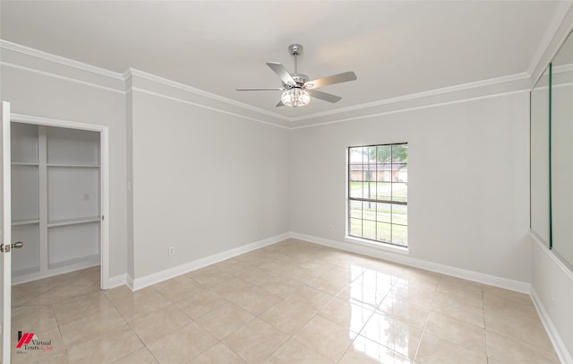 unfurnished room featuring ornamental molding, light tile patterned floors, and ceiling fan