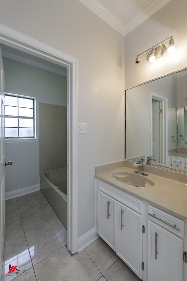 bathroom featuring vanity, tile patterned floors, ornamental molding, and a bathing tub