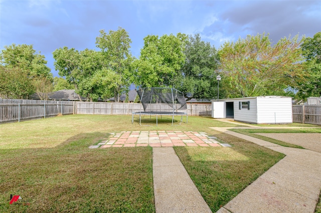 view of yard with an outbuilding and a trampoline