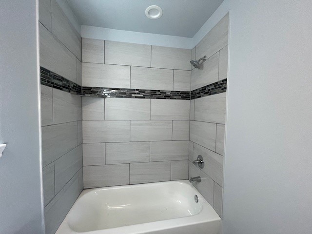 bathroom featuring tiled shower / bath