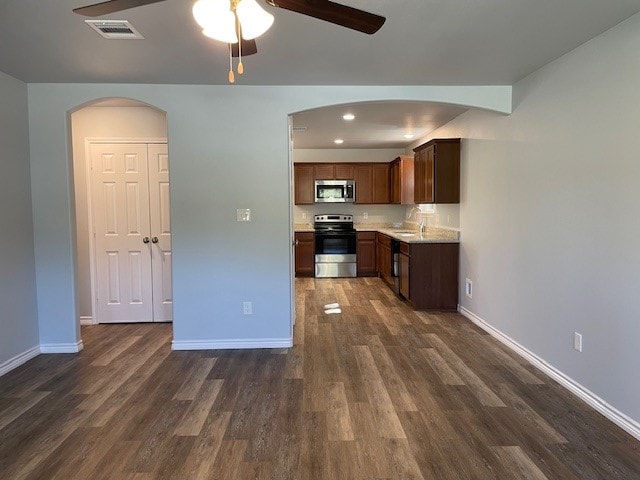 kitchen with ceiling fan, dark hardwood / wood-style floors, sink, and appliances with stainless steel finishes